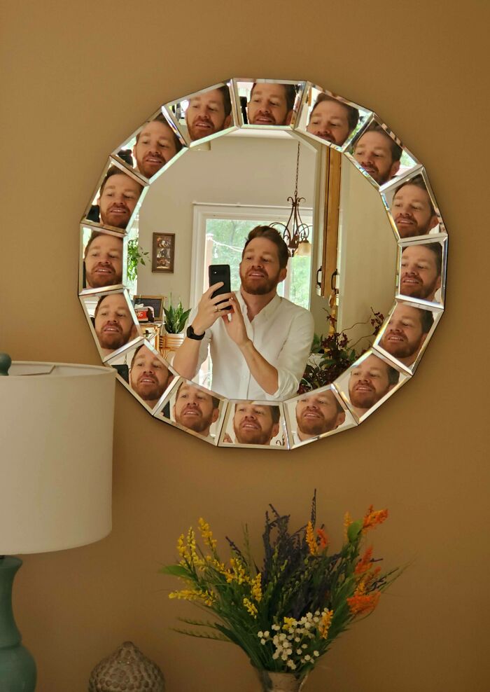 Multiple mirror reflections of man taking a picture 