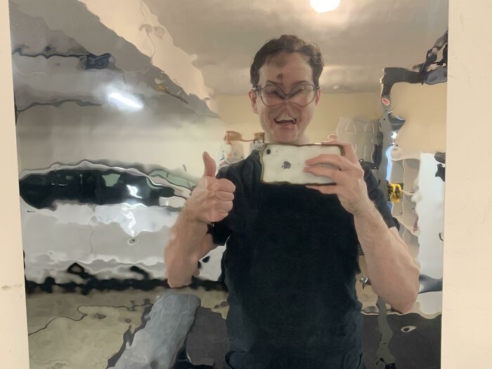 Man taking a picture of himself in a blurry mirror 