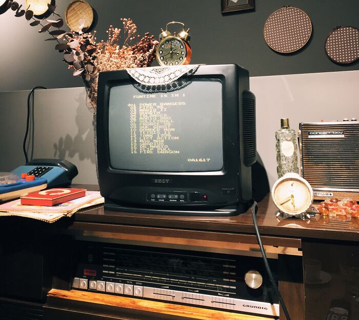 Old Tv On The Table With Cloth On Top Of It 