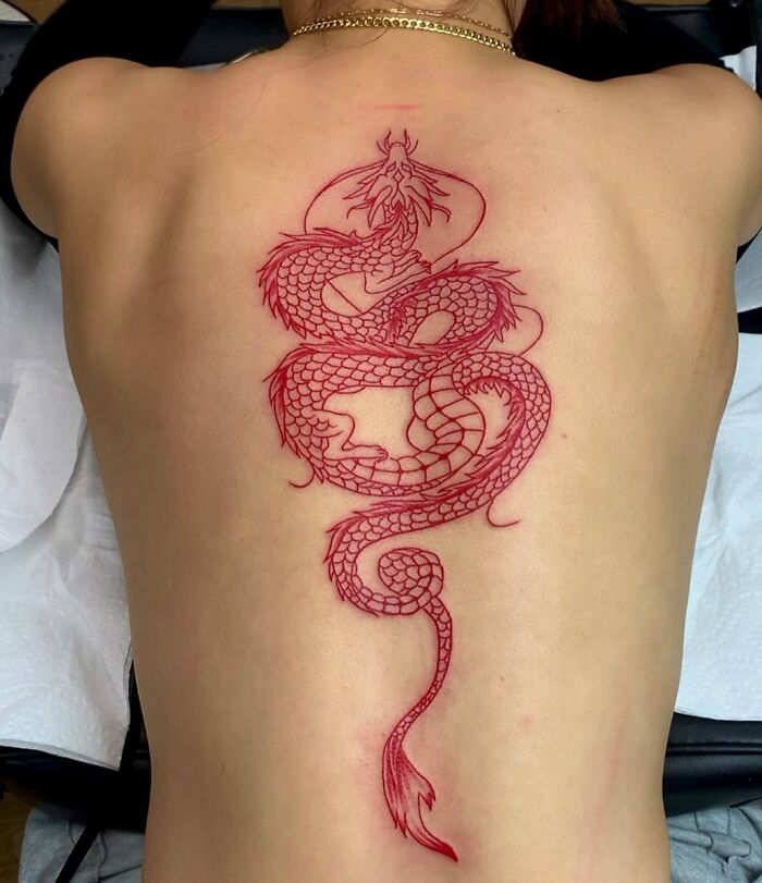 Red dragon along the spine tattoo 
