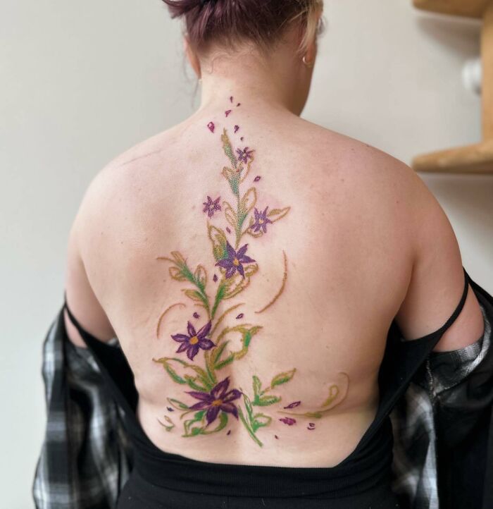 Flowers on the back tattoo 