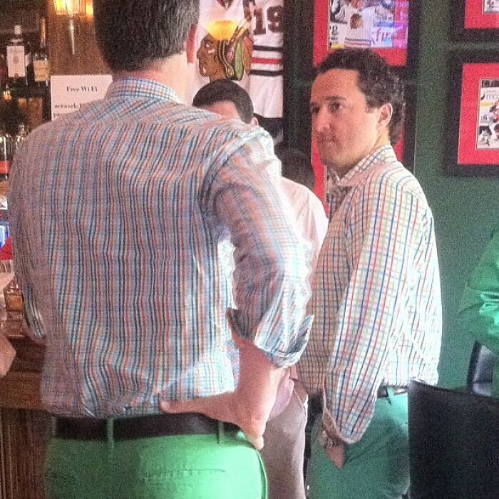 Guy looking at himself in a mirror reflection at the bar 