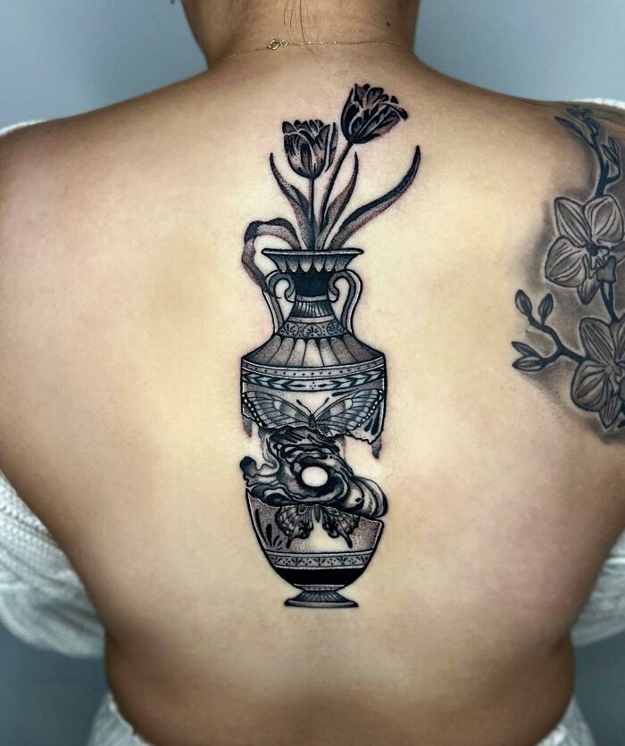 Broken vase with tulips in it spine tattoo 