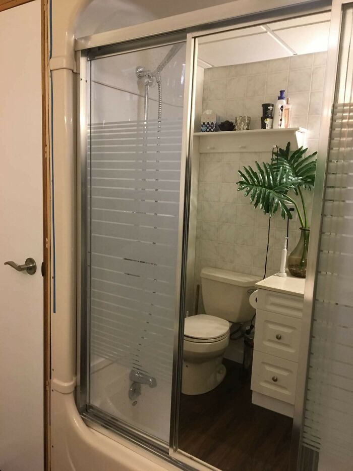 Funny mirror reflection making it look like a toilet is in a shower 