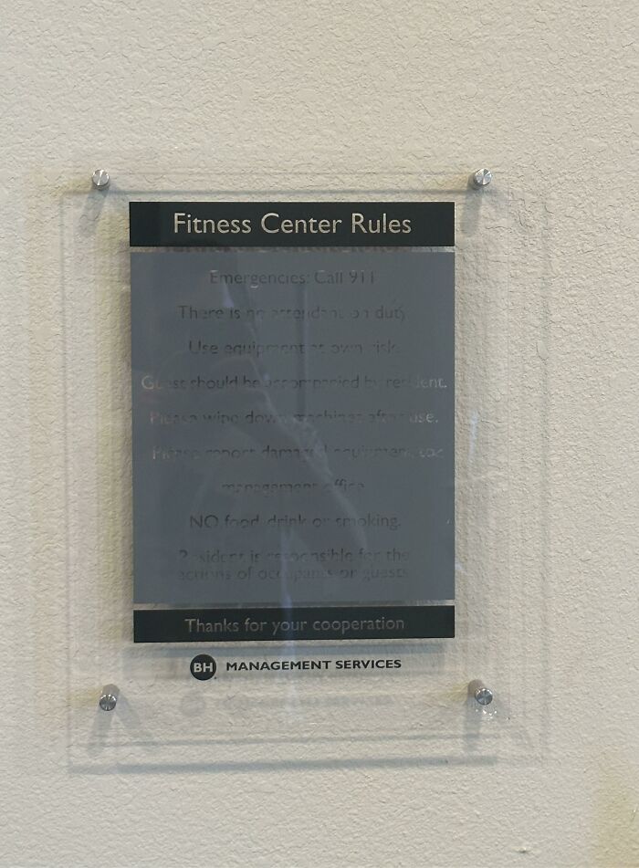 A Glass Sign Casting A Shadow On Itself. Every Placard In The Building Looks Like This