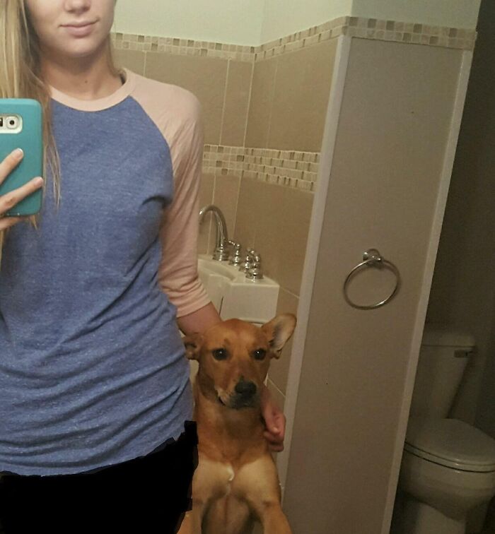 Woman and her dog taking a mirror picture 