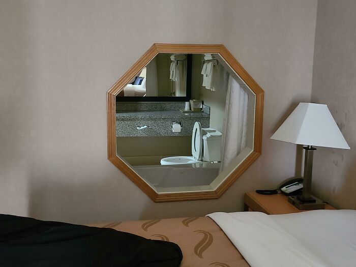 Mirror reflection of a bathroom seen in a bedroom 