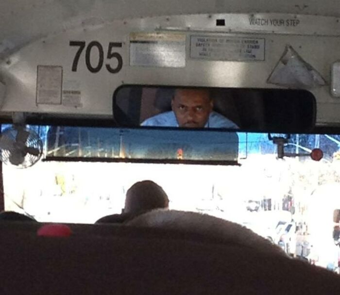 Driver looking angry while driving a bus 