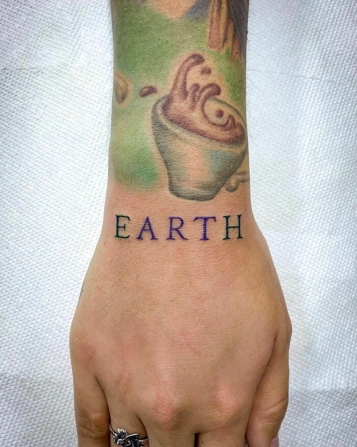 “Earth” Lettering Tattoo In Green & Purple To Add To This Alice In Wonderland Sleeve