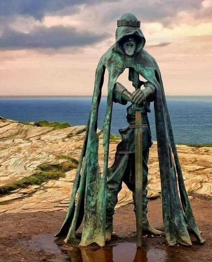 King Arthur's Statue Overlooking The Atlantic Ocean On The Cliffs Of Tintagel In Cornwall, England