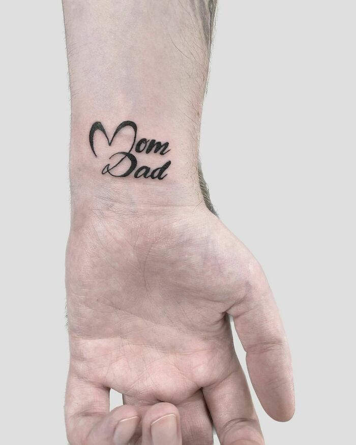 wrist tattoo with words mom and dad