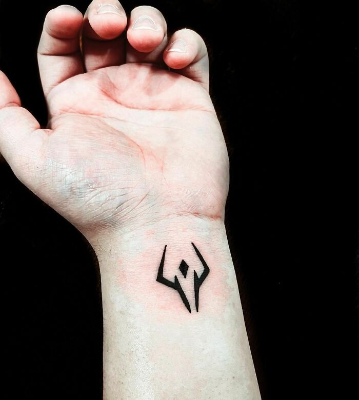 Symbol wrist tattoo