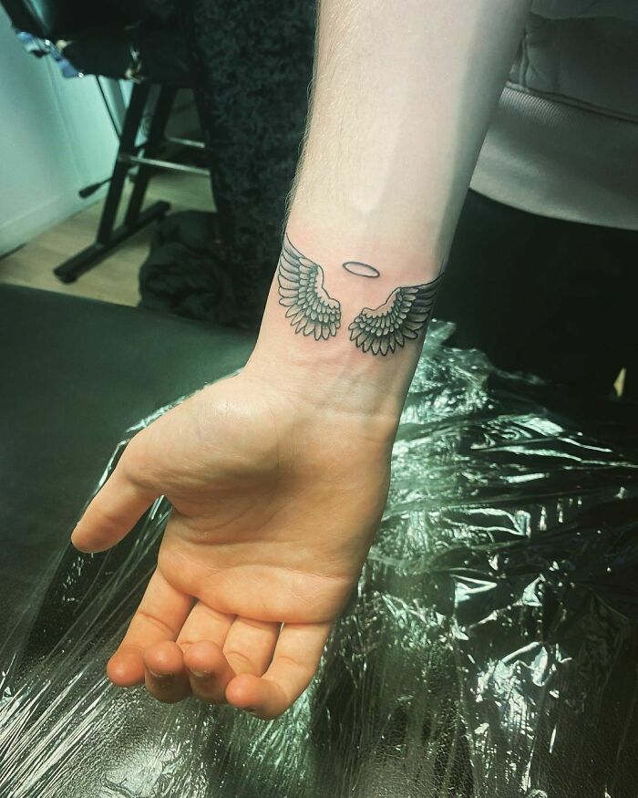 Angel wings tattoo on wrist
