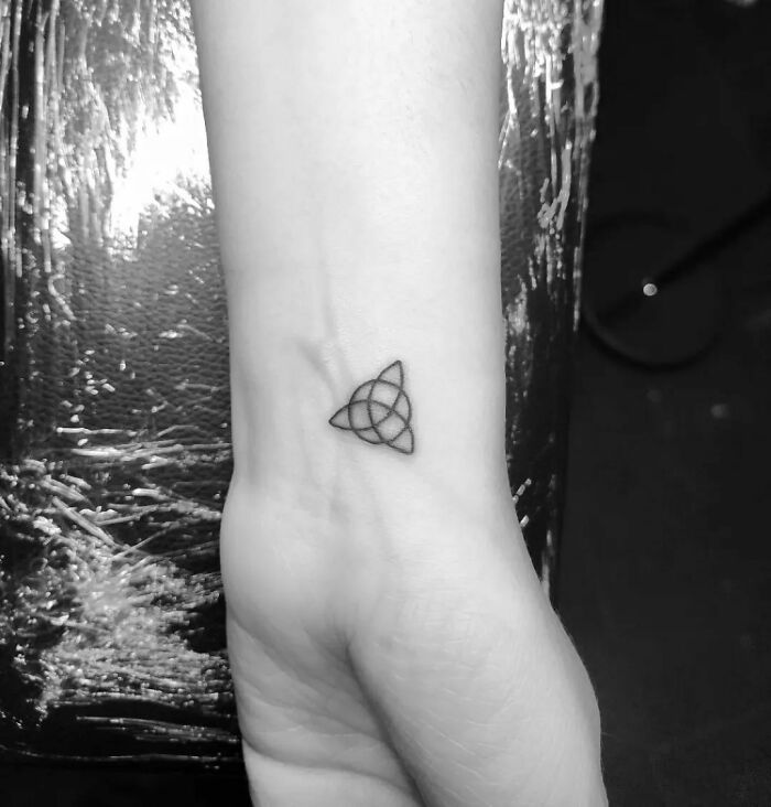 Tiny triquetra tattoo on wrist