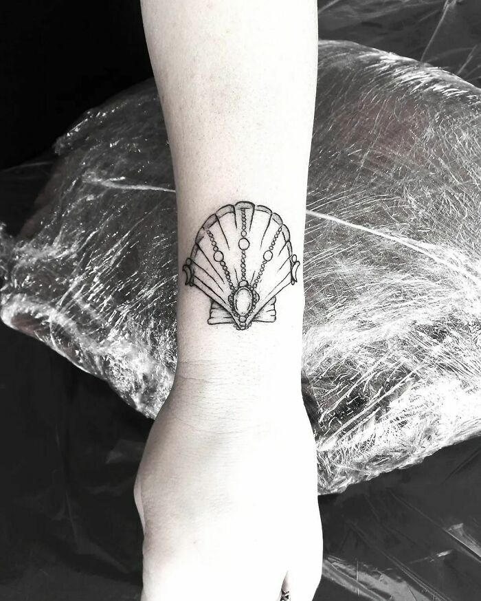 Shell wrist tattoo