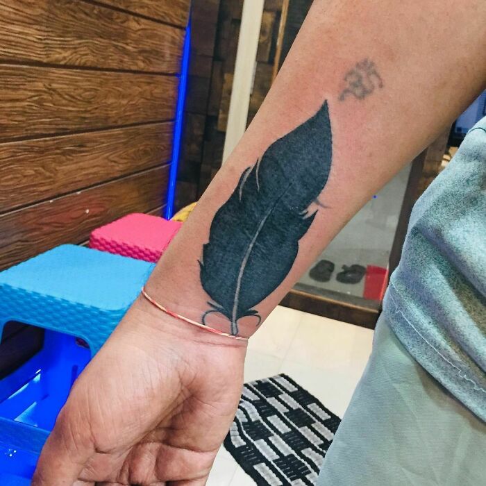 Feather tattoo design on wrist