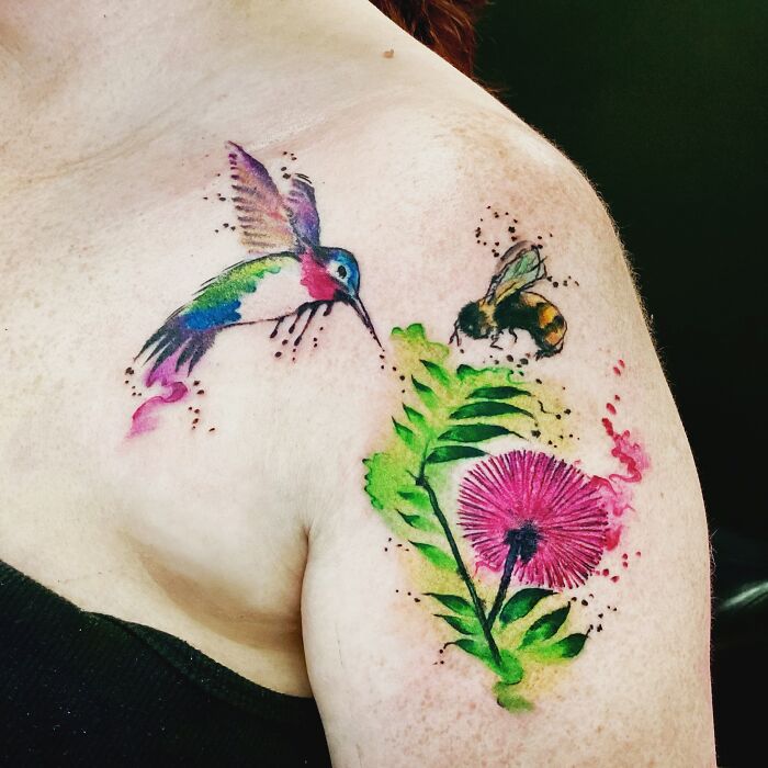 Colorful tattoo of a hummingbird, bee, and flower on shoulder, showcasing cool tattoo design.