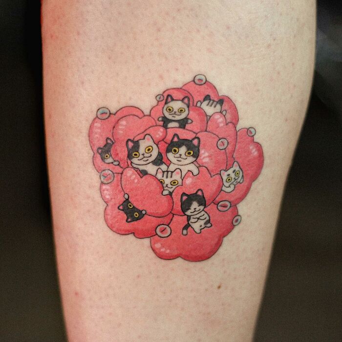 Adorable animal-themed tattoo featuring cute cats within pink heart shapes.