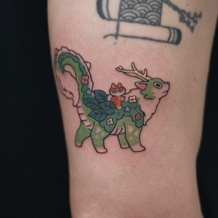 Tattoo of a whimsical animal with antlers and floral patterns, showcasing an adorable animal-themed design.