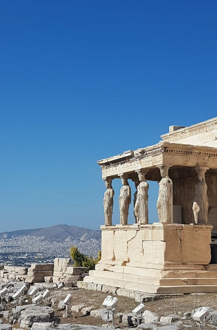 Athens, Greece A Caryatid Is A Sculpted Female Sculptural Figure Used As A Pillar, Serving As An Architectural Support. The Greek Term Karyatides Literally Comes From An Ancient Town In The Peloponnese, Meaning "Daughters Of Karyai"
