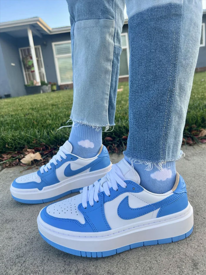Person wearing blue sneakers with big platforms