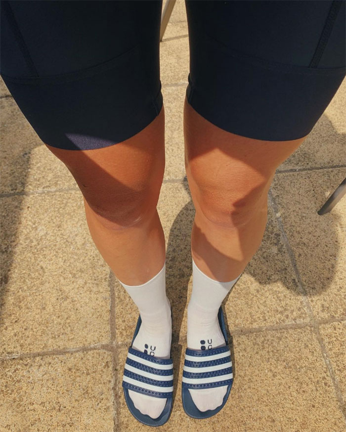 Women wearing socks and sliders