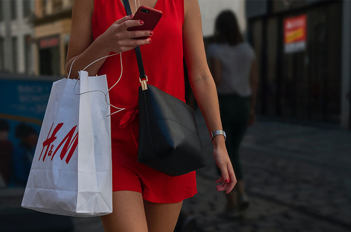 Women walking down the street with a shopping bag