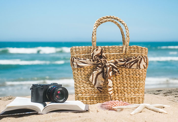 Bag book and camera at the beach