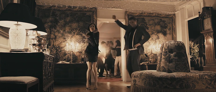 A couple dancing in the room at the house party from RocknRolla