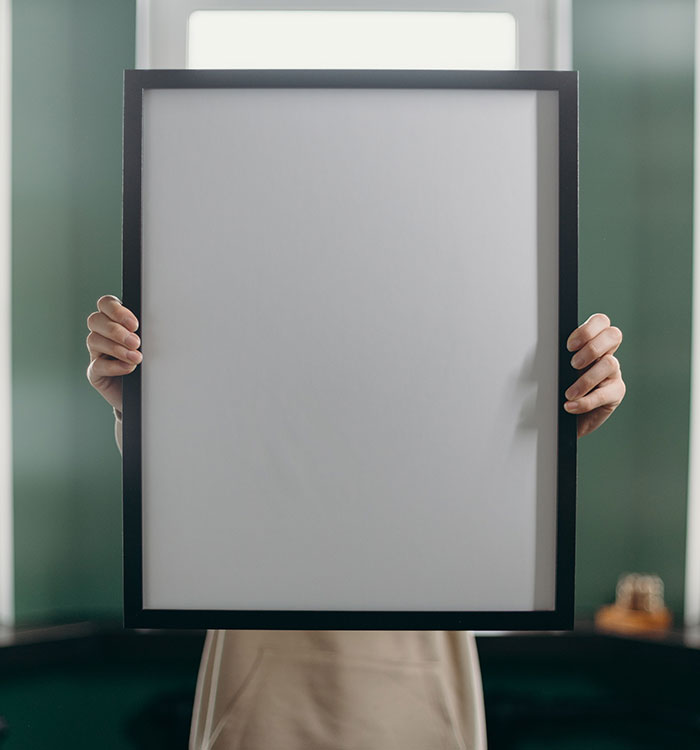 Person holding white and black frame