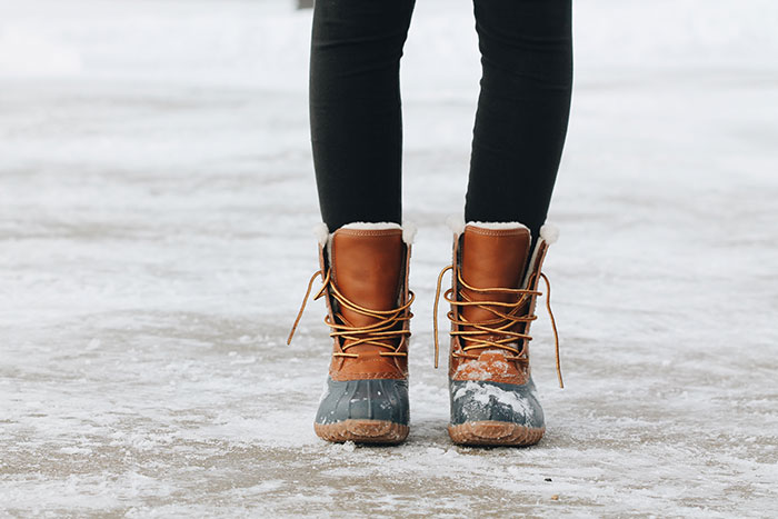 Person standing on brown ground with winter shoes