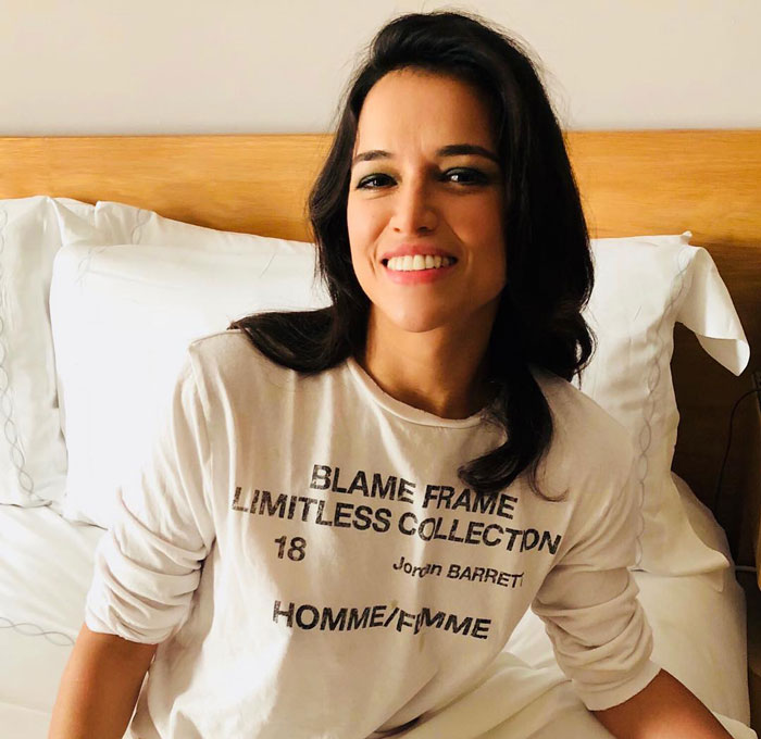 Celebrity smiling in a white shirt, connected to jail-related article.