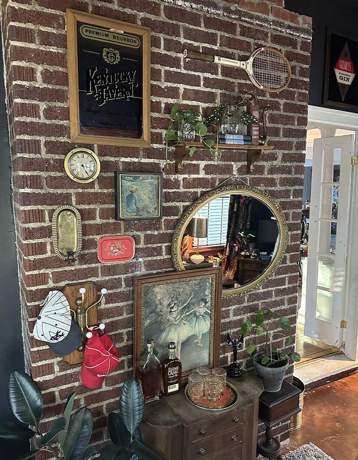 Wall with posters, mirror and tennis racket