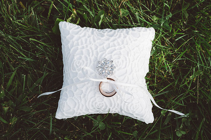 White pillow with ring on the grass