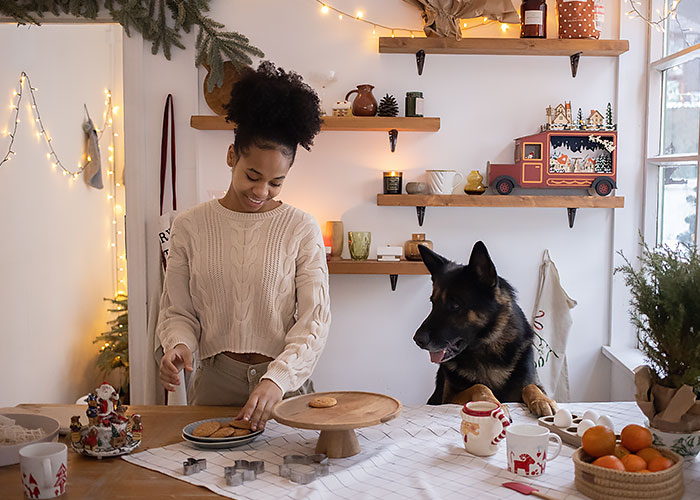 Woman and dog looking at cookies