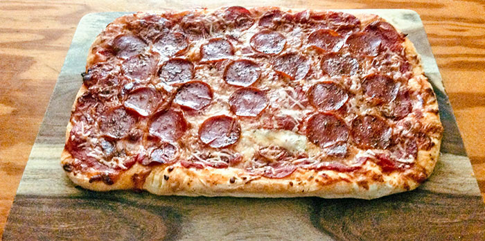 Thaw Out Your Self-Rising Frozen Pizza, Stretch It Out On A Greased Sheet Pan, Add Additional Sauce & Toppings And Bake At 425 F