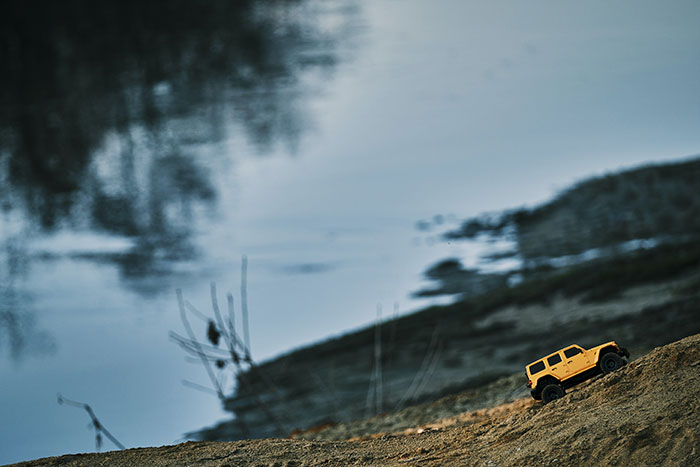 Small yellow truck on sand