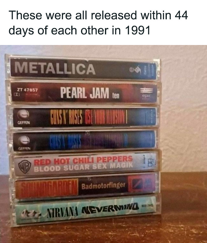 Stack of classic 1991 rock cassette tapes, featuring Metallica, Pearl Jam, Guns N' Roses, Red Hot Chili Peppers, Soundgarden, Nirvana.