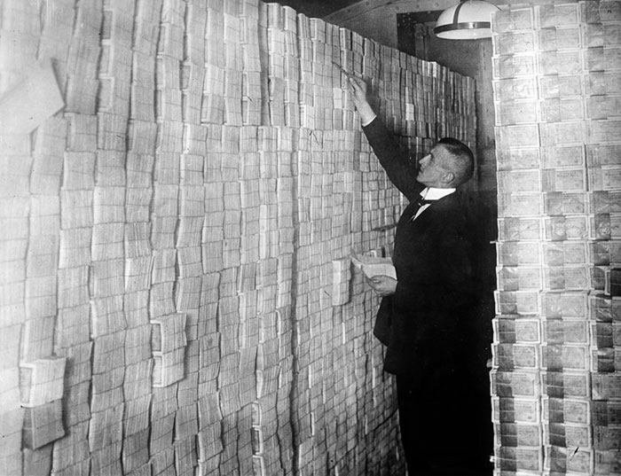A Berlin Banker Counting Stacks Of Bundled Marks In 1923