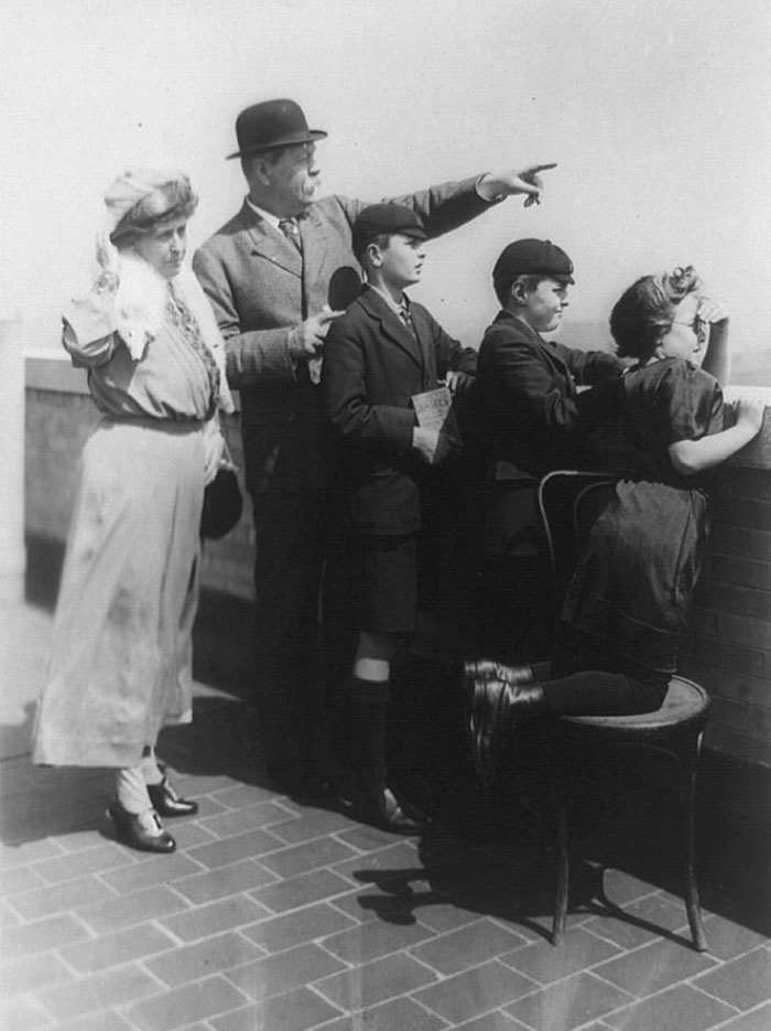 Sir Arthur Conan Doyle And His Family Looking Over The Wall And Pointing To New York City