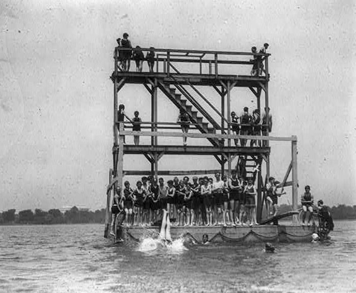 Swimmers On Wooden Structure In The Potomac River. Lincoln Memorial In The Background. Washington, D.C.