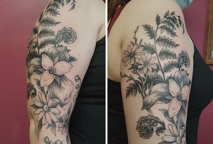 Floral nature tattoos on a person's upper arm, showcasing intricate flowers and leaves in black ink.