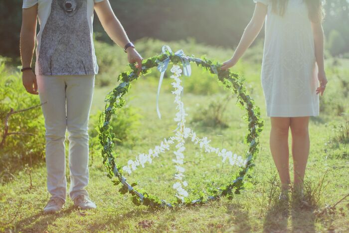 Couple Holding A Natural Piece Sign 