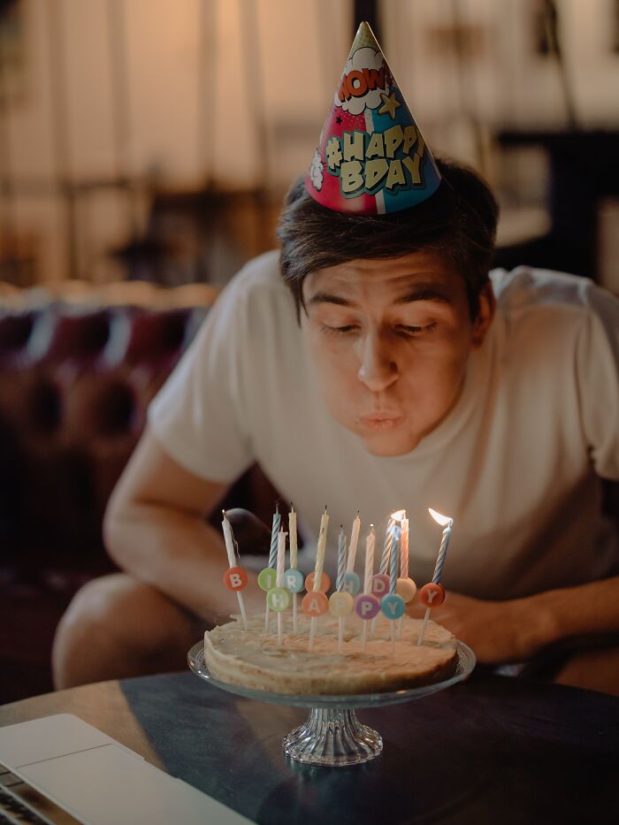 Person wearing birthday hat and celebrating birthday