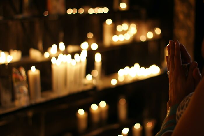 Human Praying In Candle Lights 