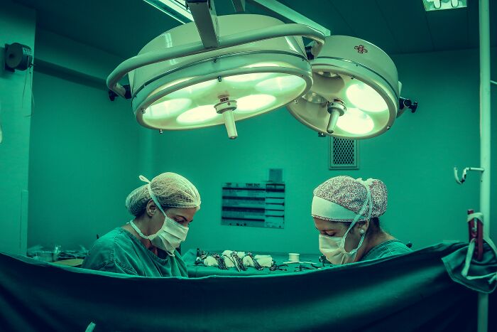 Women Doing An Operation In Poor Lighting