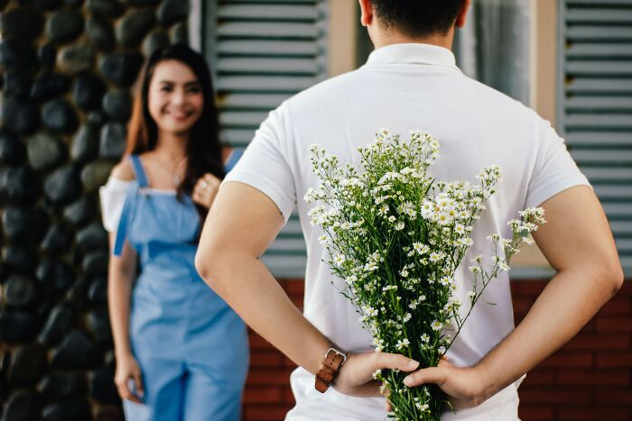 Man Holding Flowers Behind His Back 