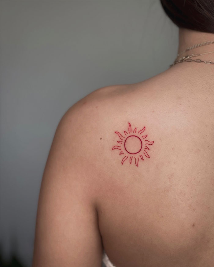 Red sun shoulder tattoo 