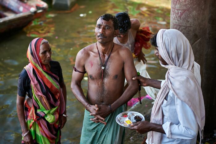 The Purification Ritual Of A Pilgrim From Sins In The Holy River Narmada In Omkareshwar, India