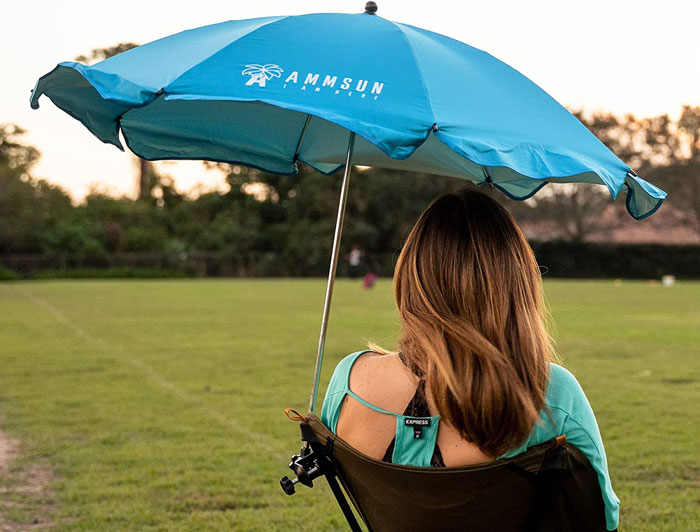 Woman sitting on the chair umbrella 